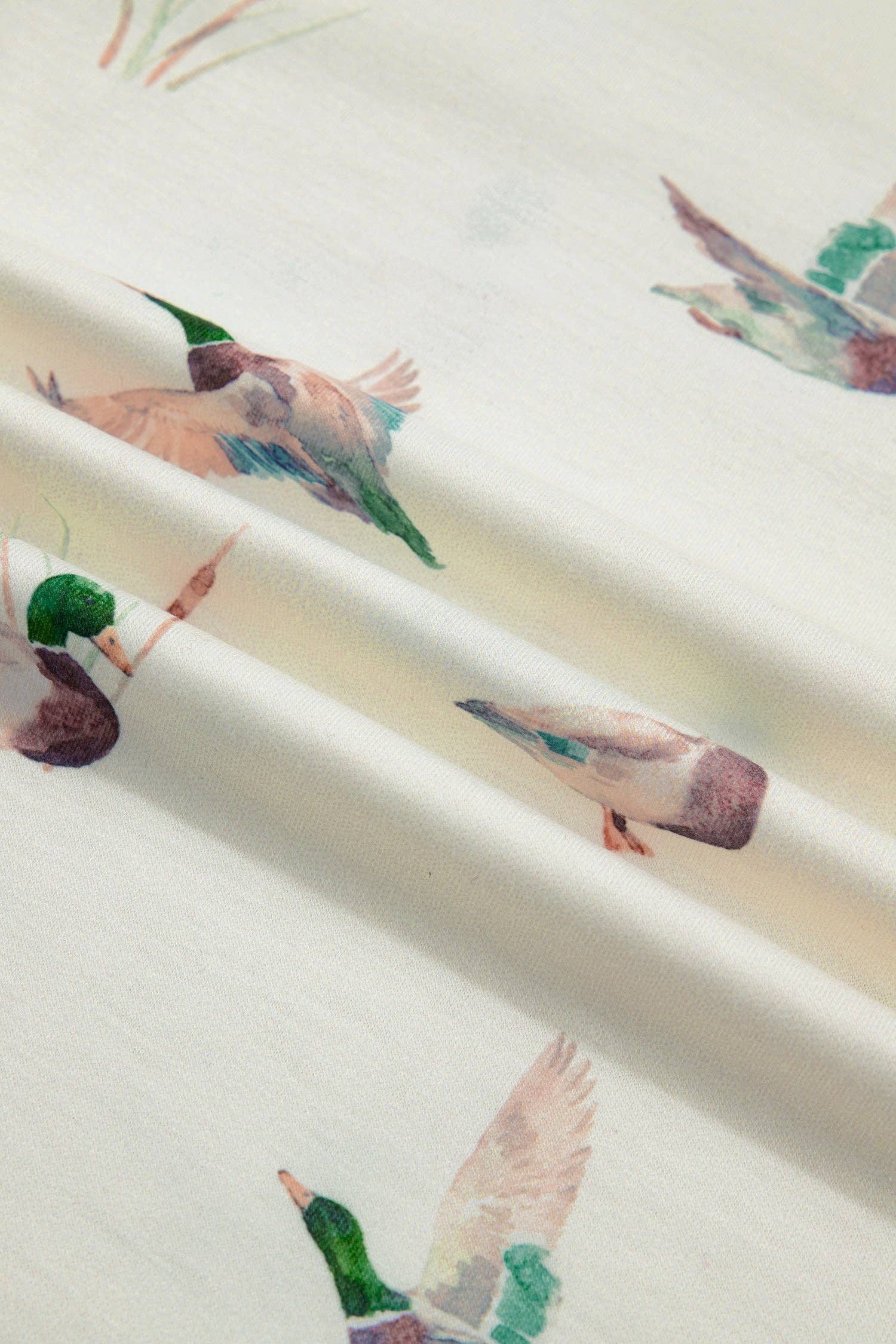 Fabric with colorful bird pattern on a white background