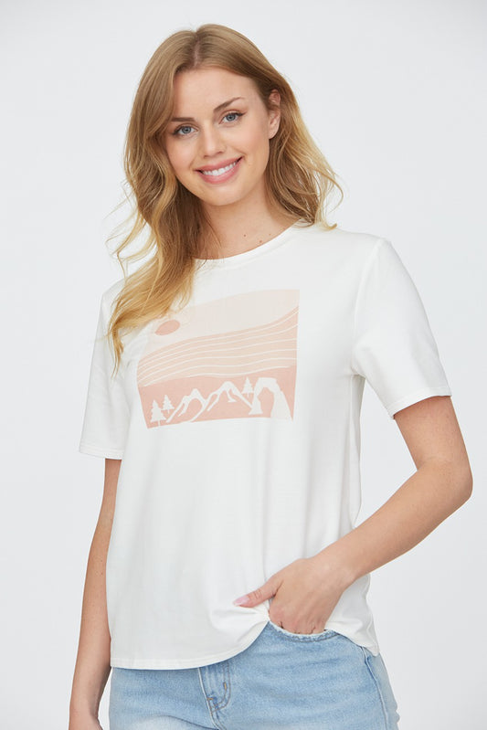 Woman wearing a mountain top with trees 