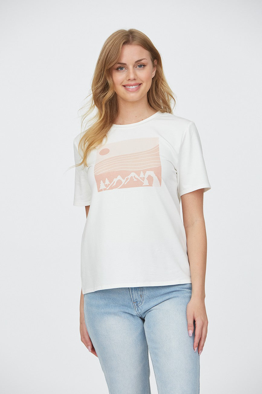 Woman wearing a mountain top with trees 