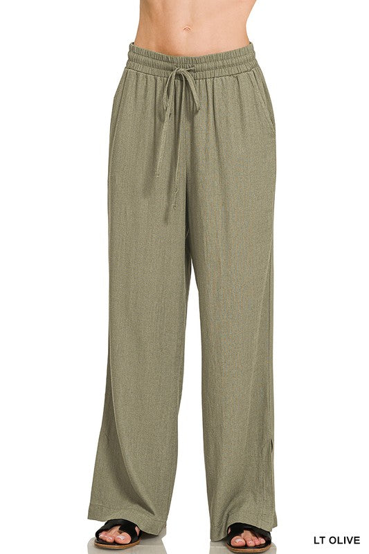 Light olive green pants with a drawstring waist on a white background