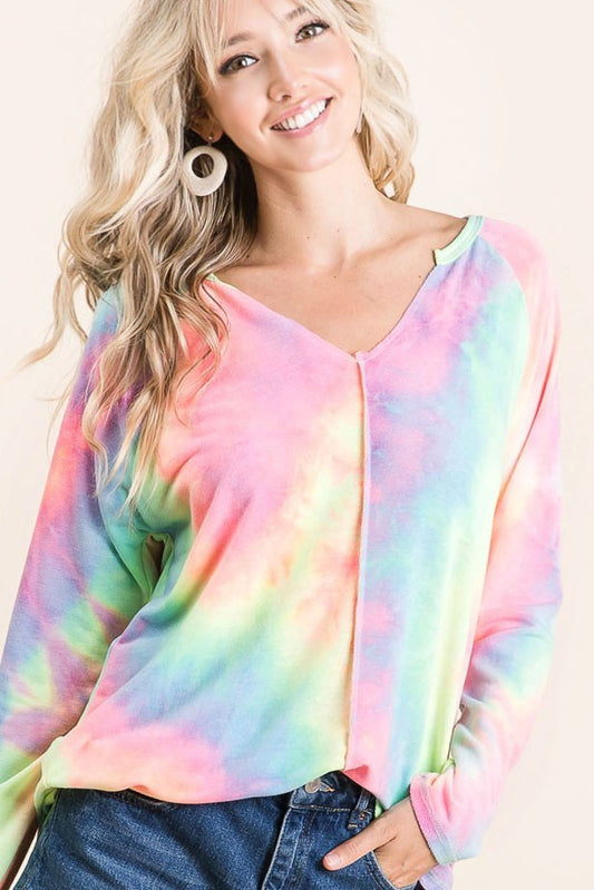 A woman wearing a long sleeve tiedye shirt 
