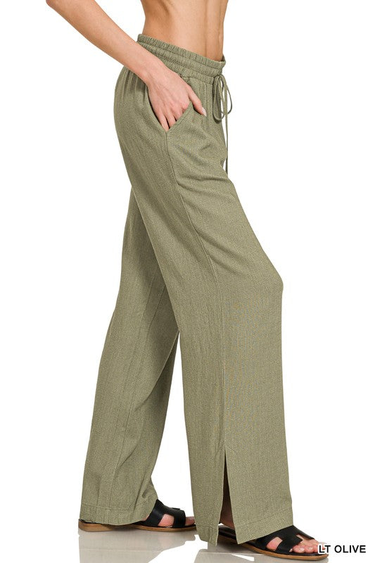 Light olive green wide-leg pants with a drawstring waist on a white background