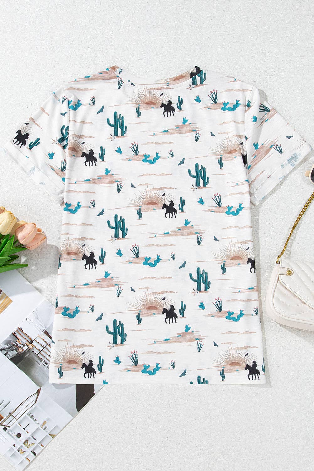 Long-sleeve shirt with desert-themed pattern on a white surface