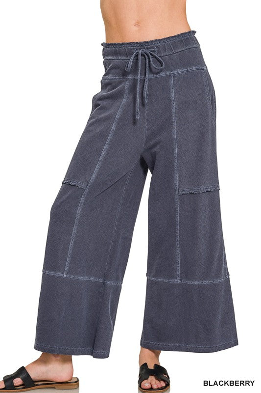 Dark blue wide-leg pants with a drawstring waist on a white background.