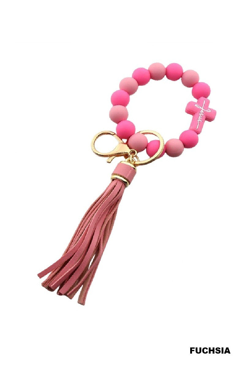 Pink beaded keychain with tassel on a white background