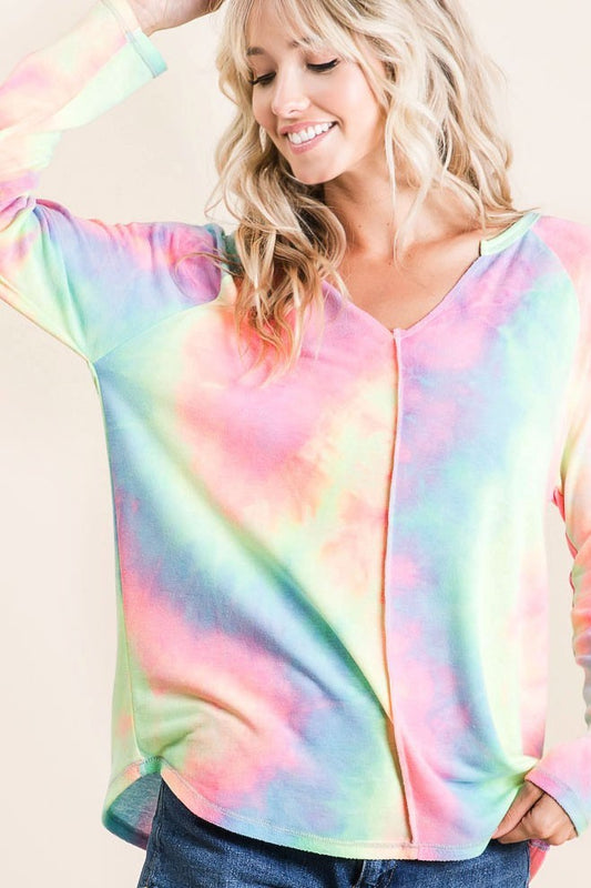 A woman wearing a long sleeve tiedye shirt 