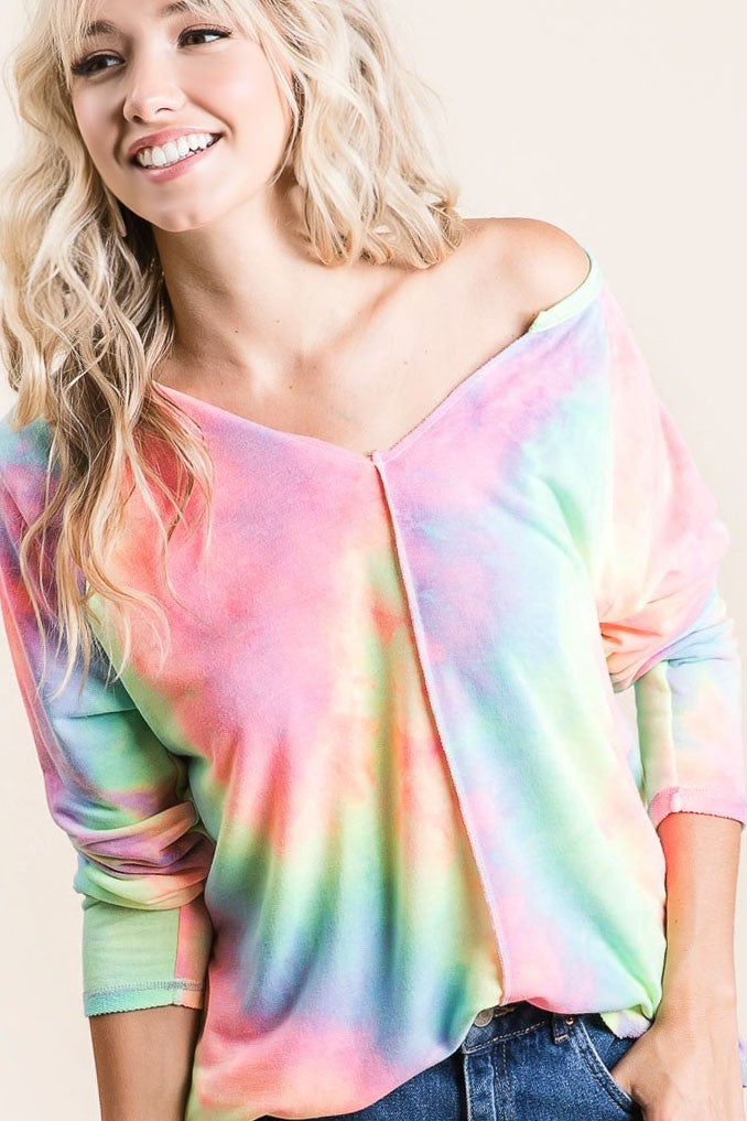 A woman wearing a long sleeve tiedye shirt 