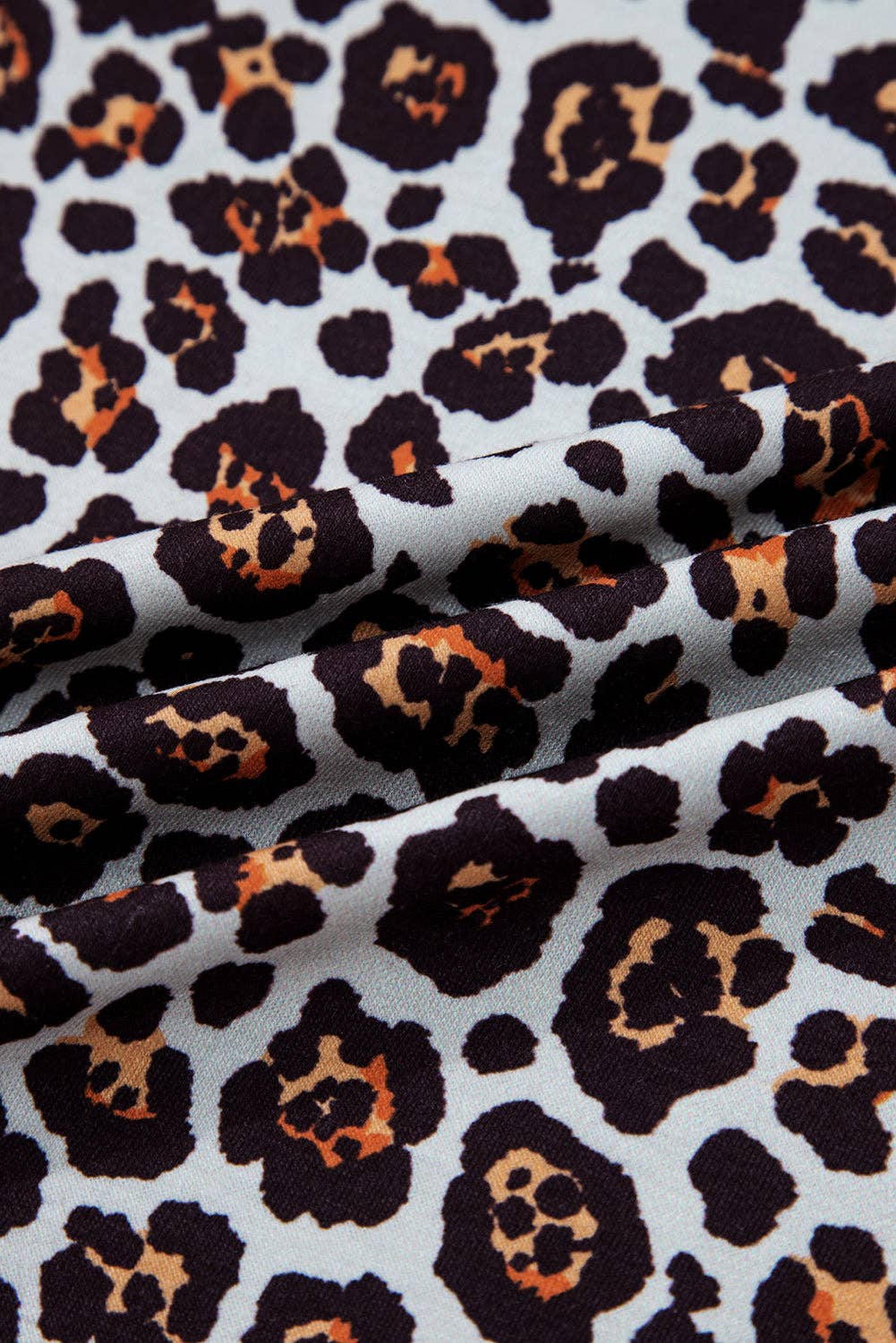 Leopard print fabric pattern on a white background
